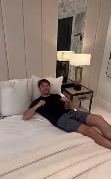mark wright led on bed in shorts