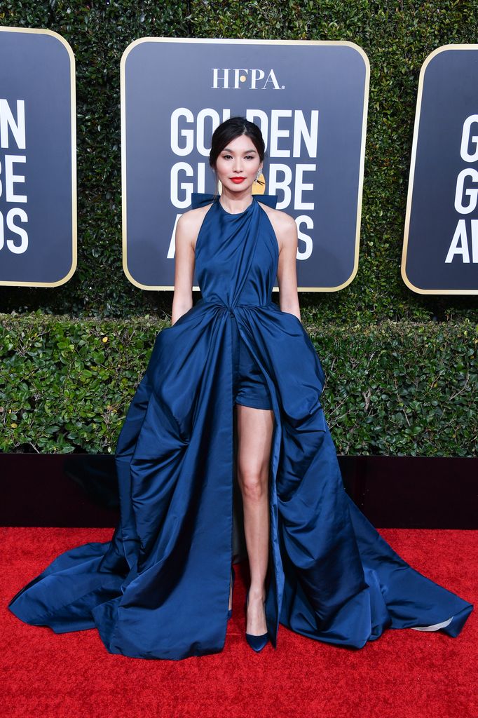 Gemma Chan on red carpet in petrol blue gown