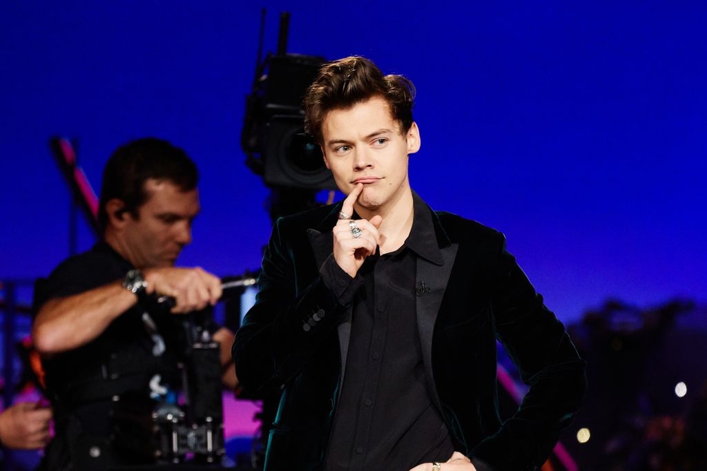 Harry Styles pulling a cheeky face on stage 