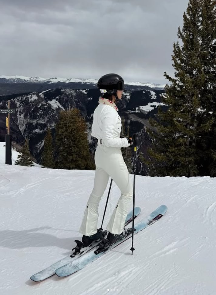 woman in white ski jumpsuit
