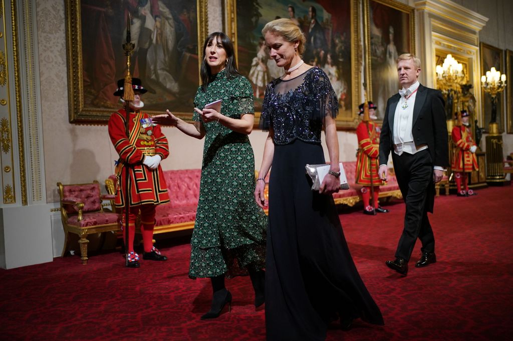 Two ladies walk side by side in Buckingham Palace