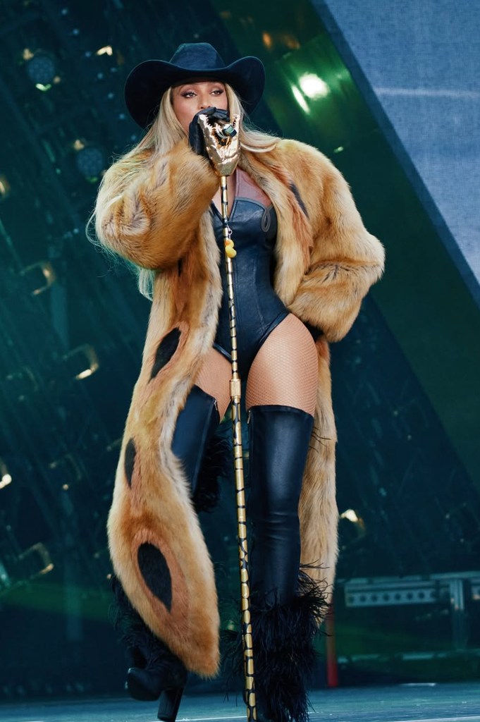 Beyoncé in black bodysuit and faux fur coat on stage in London