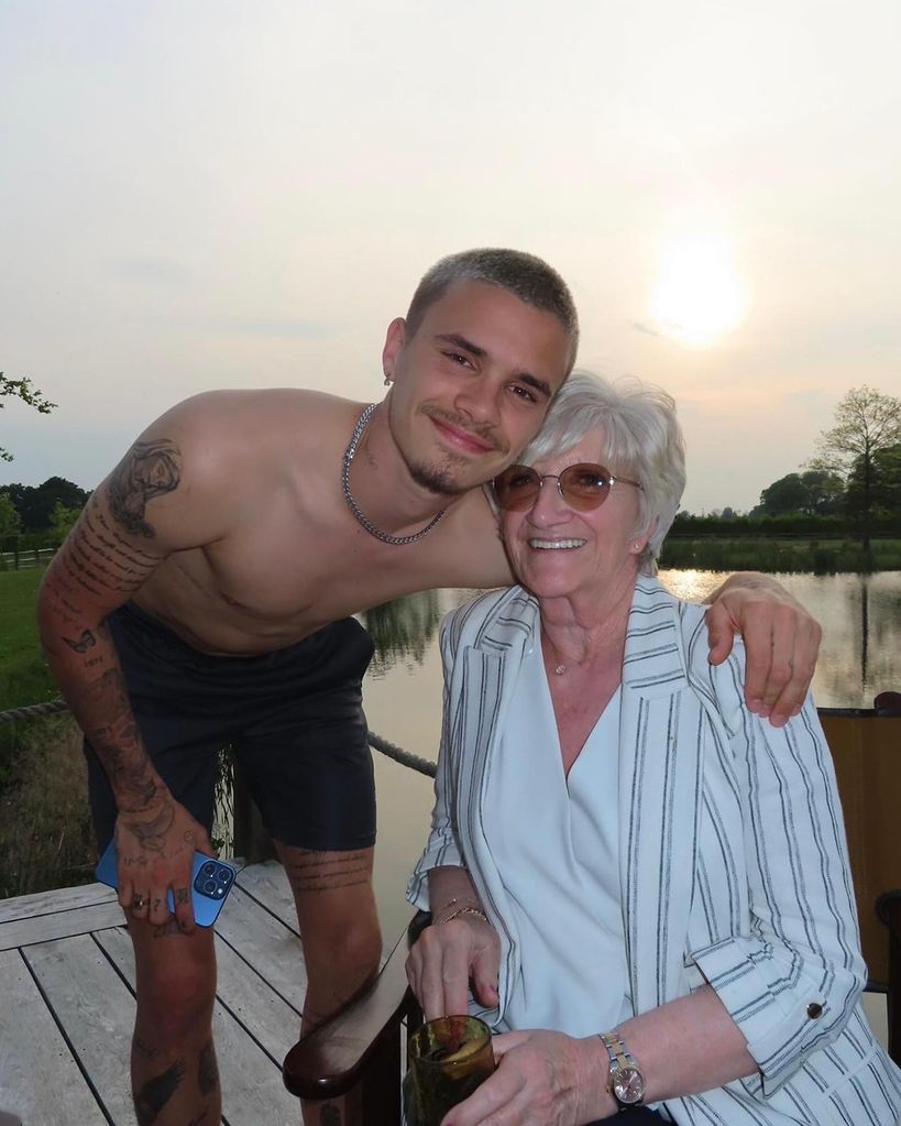 grandson posing for photo with grandmother