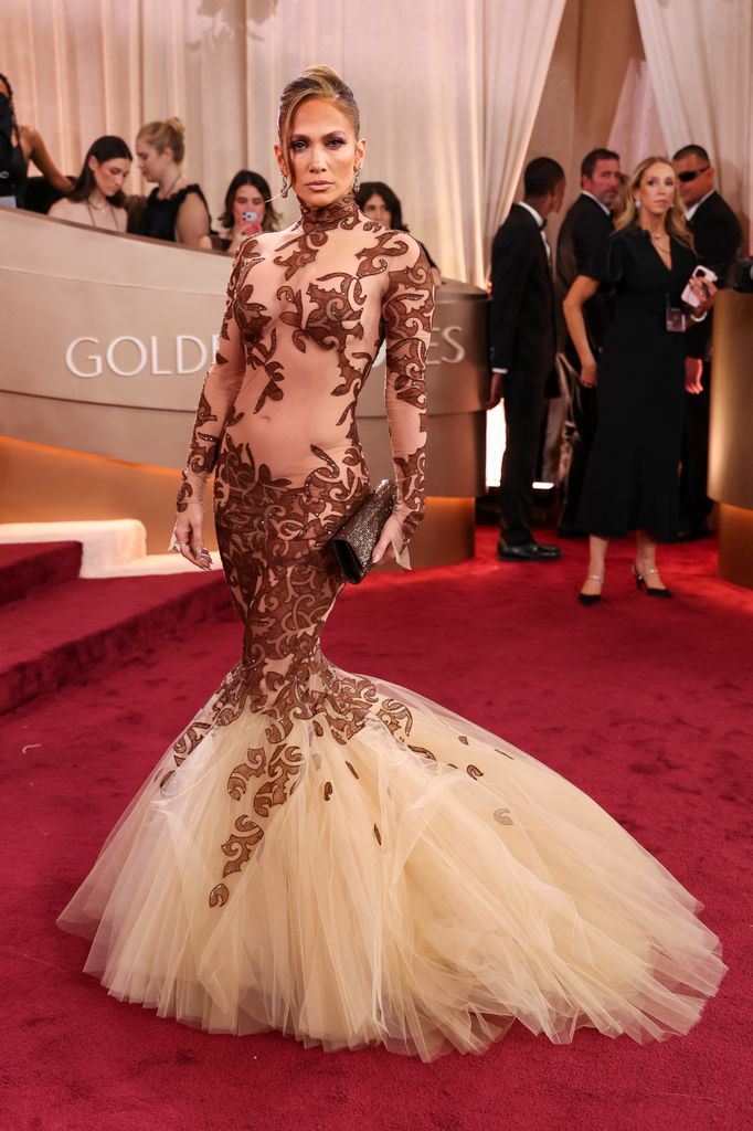 Jennifer Lopez wearing vintage Jean-Louis Scherrer - a sheer mesh dress with swirling embroidery and a huge trumpet hem