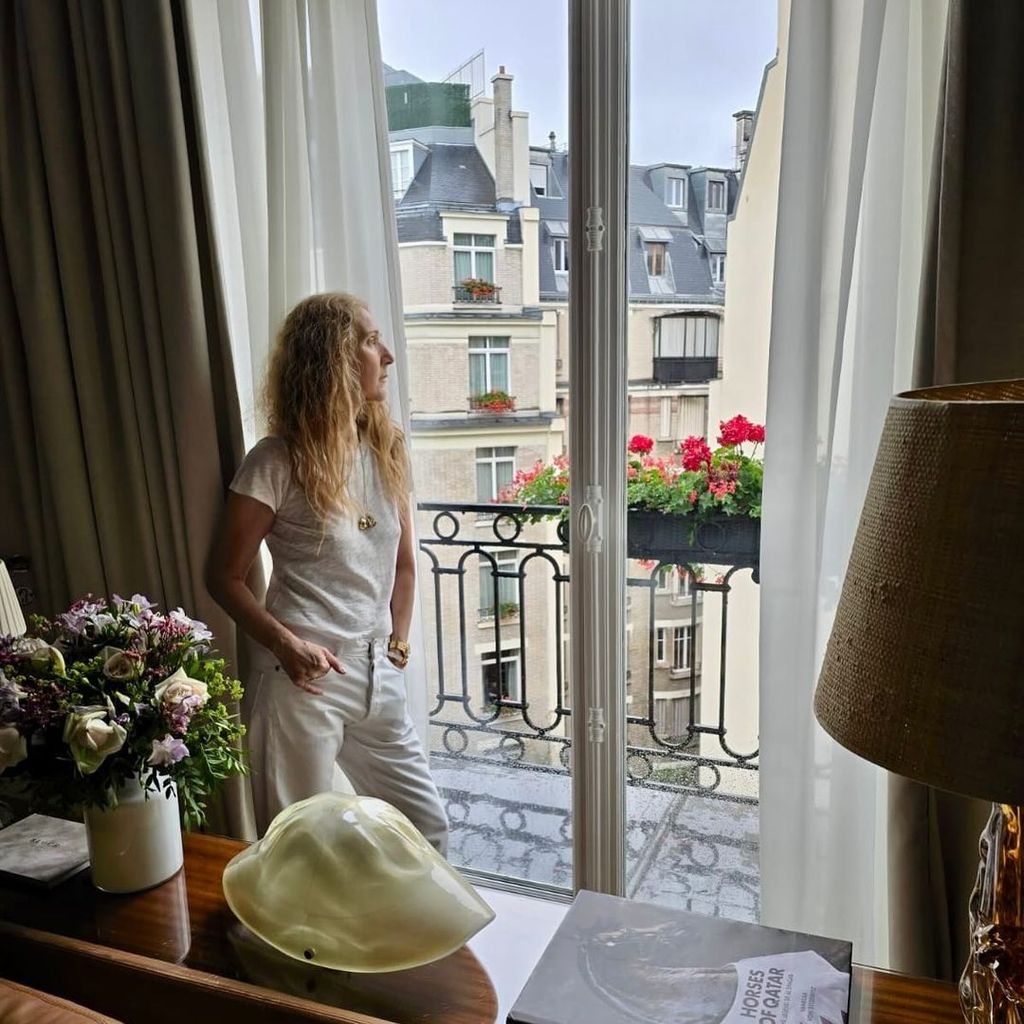 Celine Dion poses for a photograph in her hotel the morning after the 2024 Summer Olympics opening ceremony, shared on Instagram