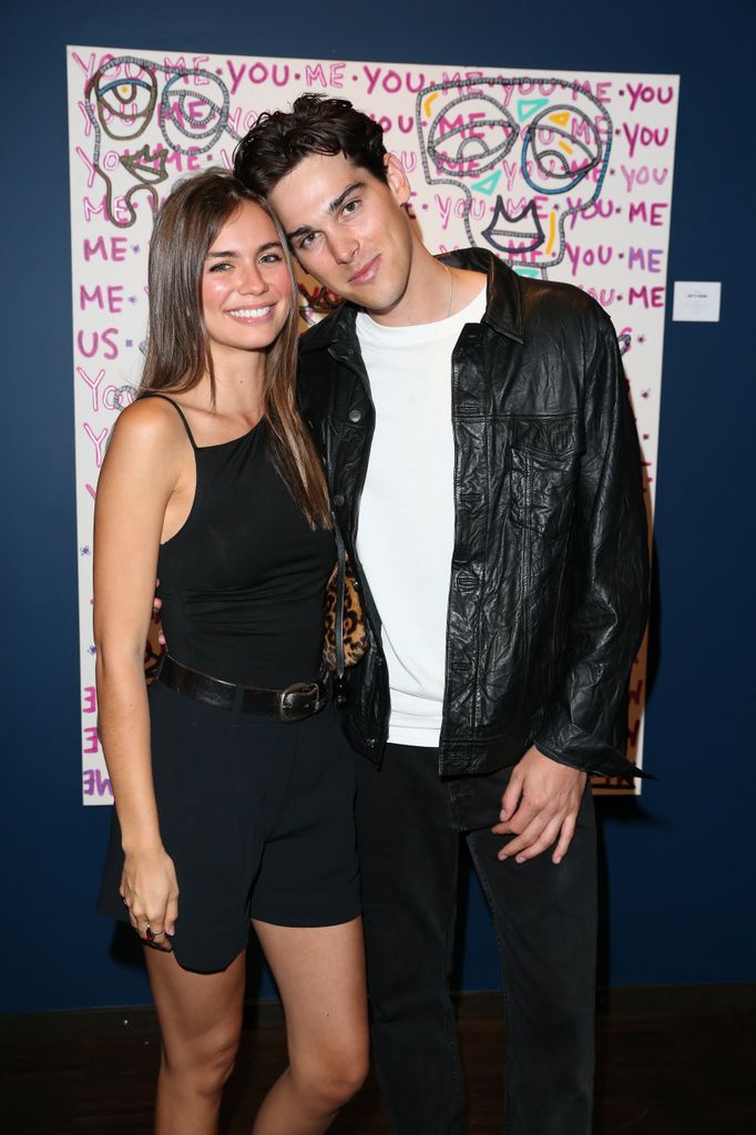 paris brosnan posing for photo with girlfriend alex lee aillon in front of his painting