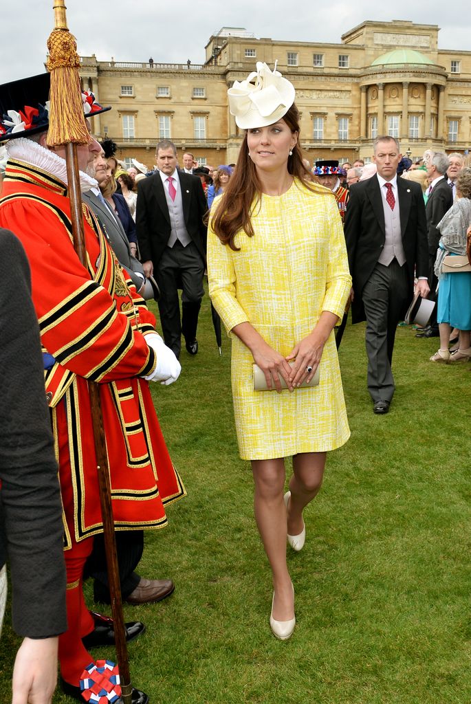 Catherine in the grounds of Buckingham Palace in yellow coat dress