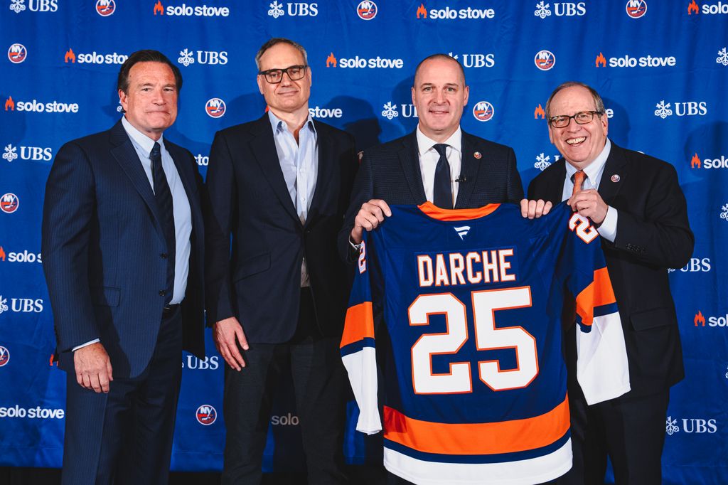 Mathieu Darche poses for a photo with Islanders owners John Collins, Jon Ledecky and Oliver Haarmann after being named the 7th General Manager in New York Islanders history at UBS Arena, on May 29, 2025 in Elmont, New York