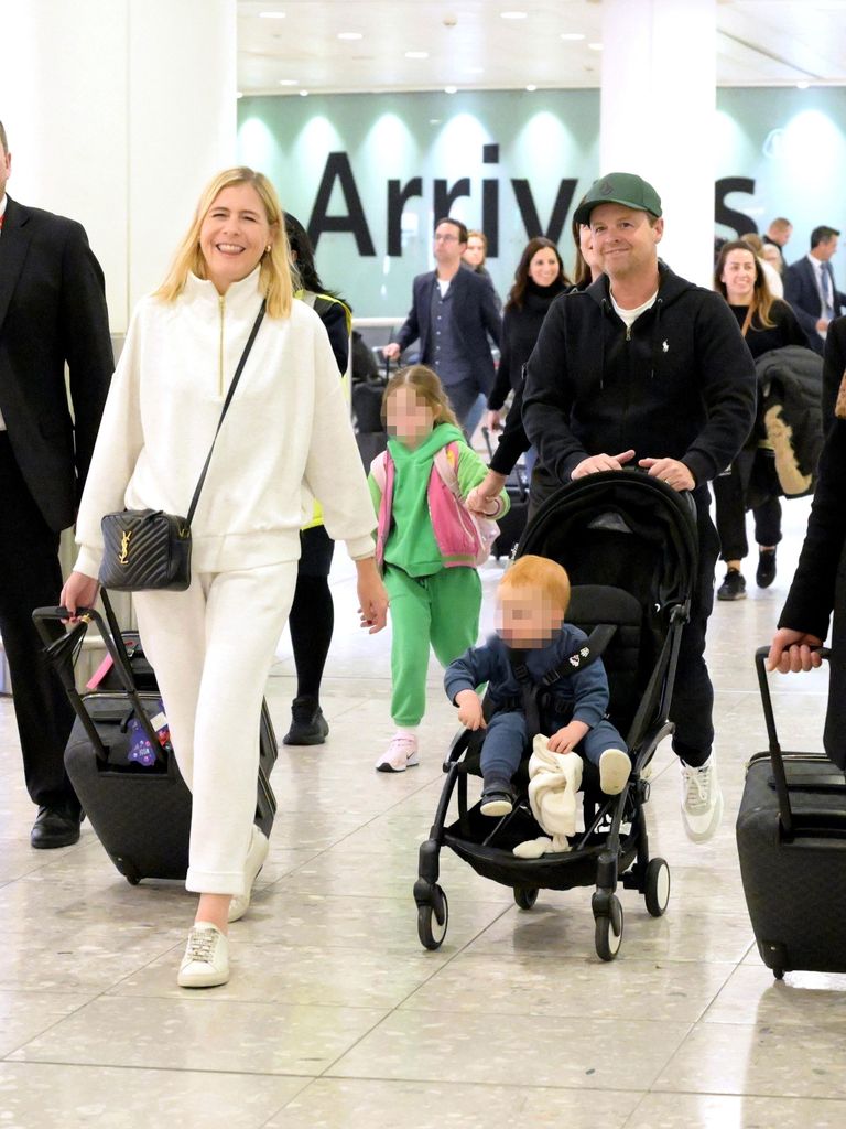 Declan Donnelly and Ali Astall were all smiles as they touched down in the UK with their two kids