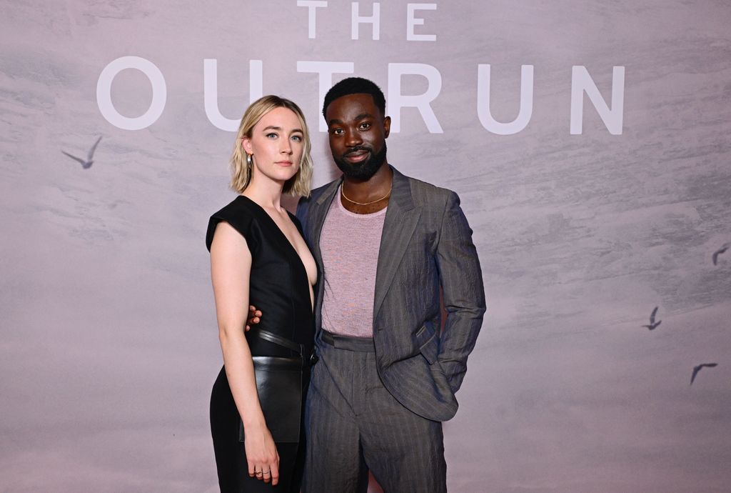 two actors posing on red carpet 