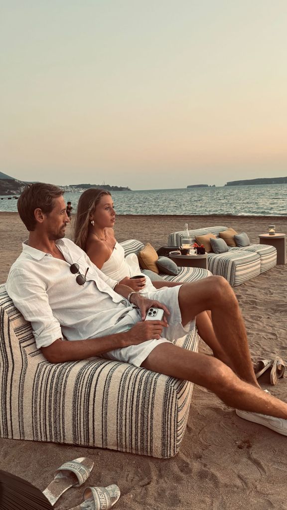 father and daughter sitting on beach