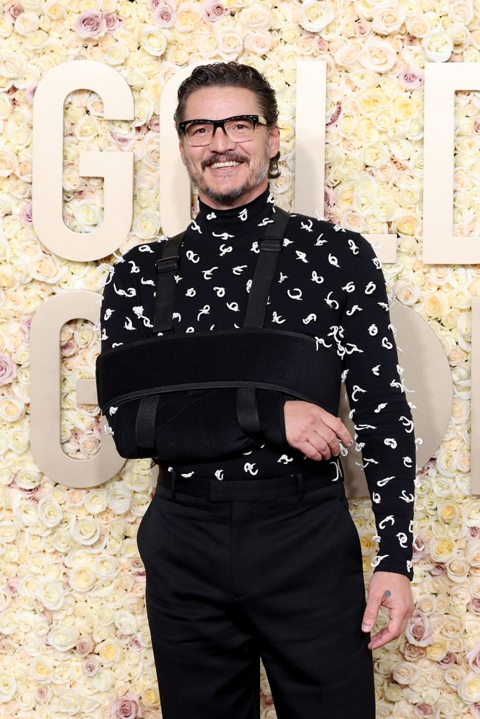 Pedro Pascal smiles in an arm sling 