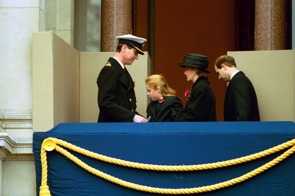 Sophie holds up Beatrice at Remembrance service