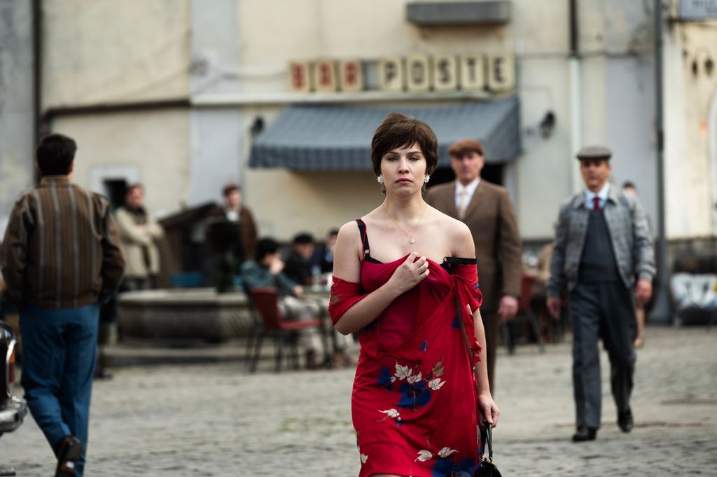 woman in wed dress walking through town