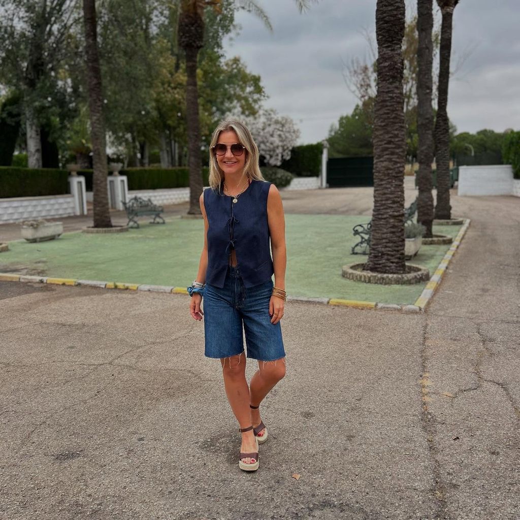 Helen in navy lace-up top with classic denim shorts outside