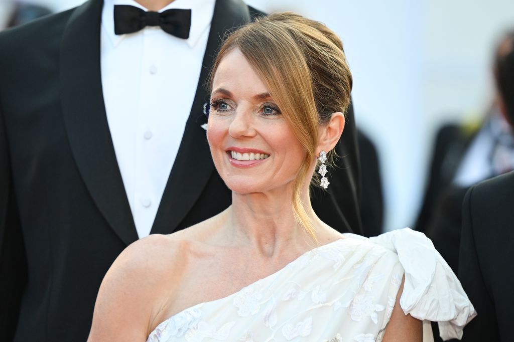 Geri Halliwell in white dress with man in tuxedo stood behind her