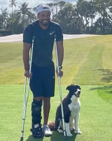 Tiger Woods on crutches standing on his own golf course at his home