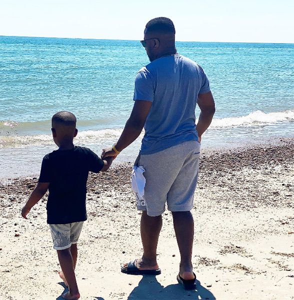 Babatunde Alesha and his son on the beach