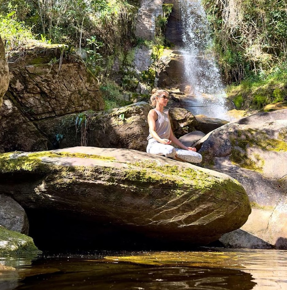 Photo shared by Gisele Bündchen on Instagram August 6, 2023 of her meditating by a waterfall during her vacation in Brazil.