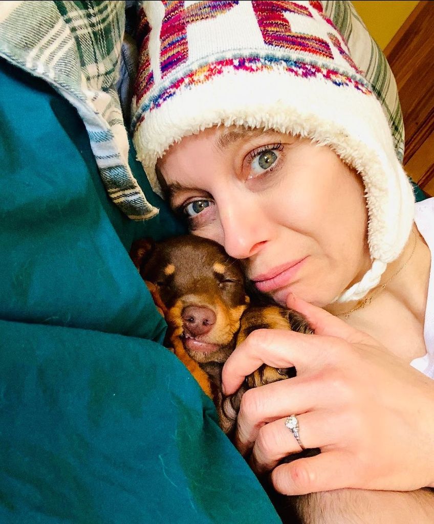 Amanda Abbington cuddling her dog wearing her diamond engagement ring