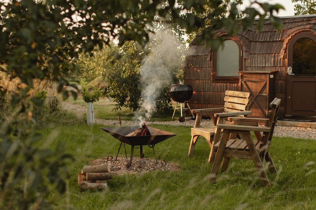 sauna lodge with wooden outdoor furniture and bbq area