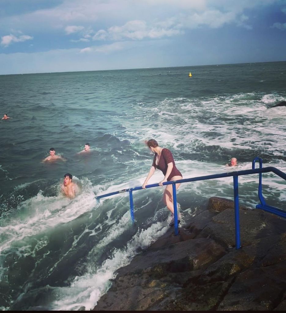 Christina Hendricks in a swimsuit wades to the Irish Sea in Dublin