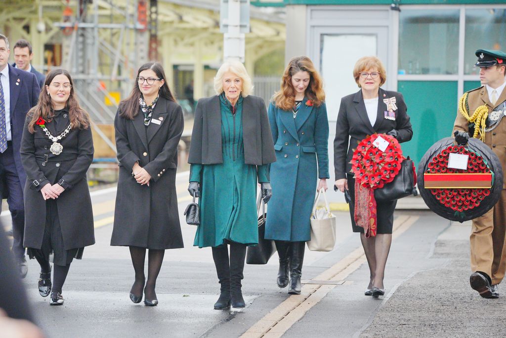 Queen Camilla and a group of women on a train platform