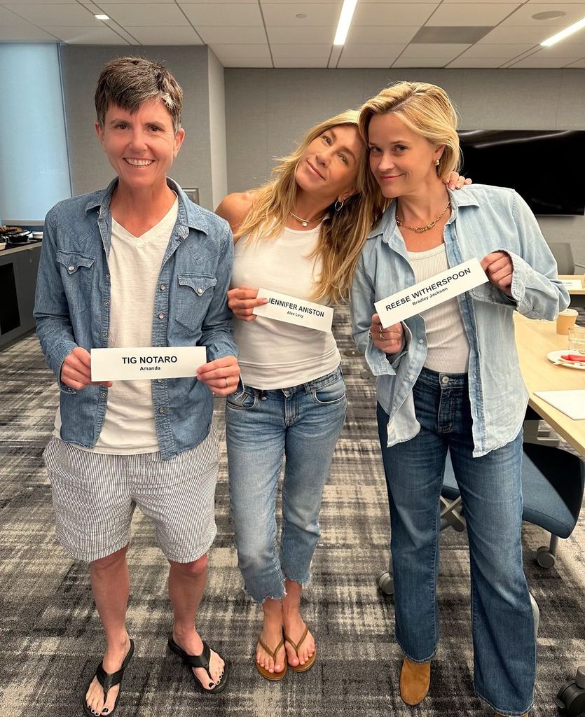 Jennifer Aniston, Tig Notaro, and Reese Witherspoon hold their character cards at the first table read for "The Morning Show" season four, shared on Instagram