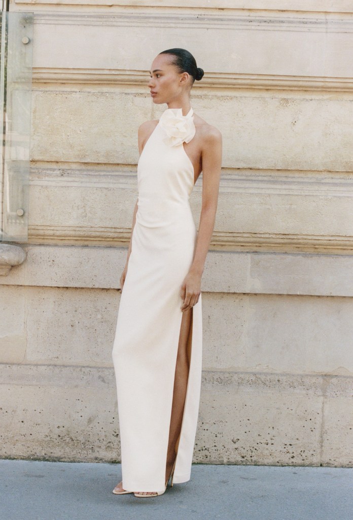 A model poses in a white halterneck dress from Mango