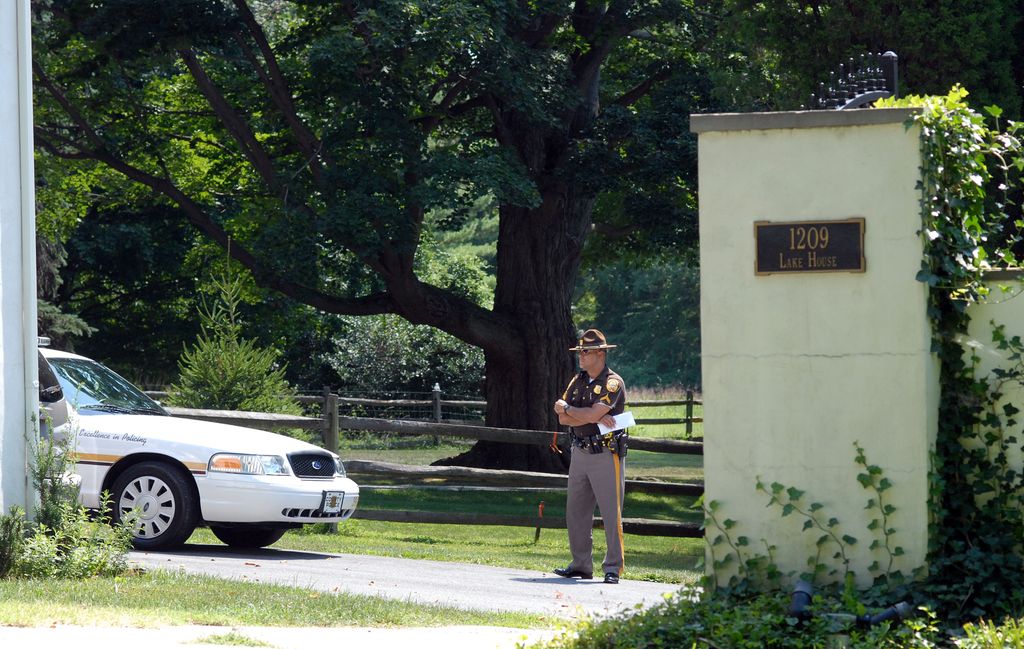 A New Castle County Police officer stands guard as media members camp out in front of Delaware Senator Joe Biden's home, 12, 2008 in Greenville, Delaware.