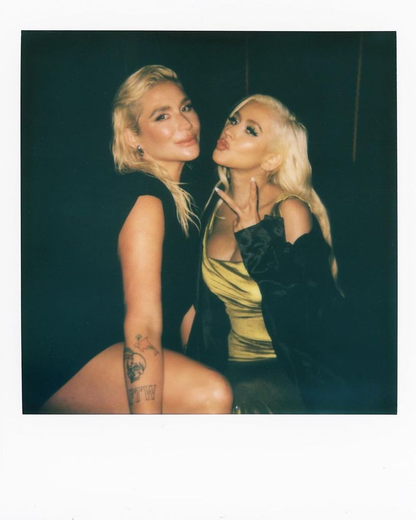 Polaroid photo of singers Kesha and Christina Aguilera posing 