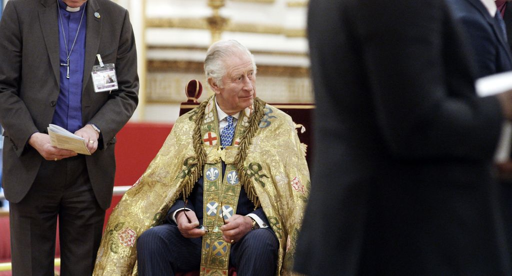 King Charles sitting in gold robe during coronation rehearsals