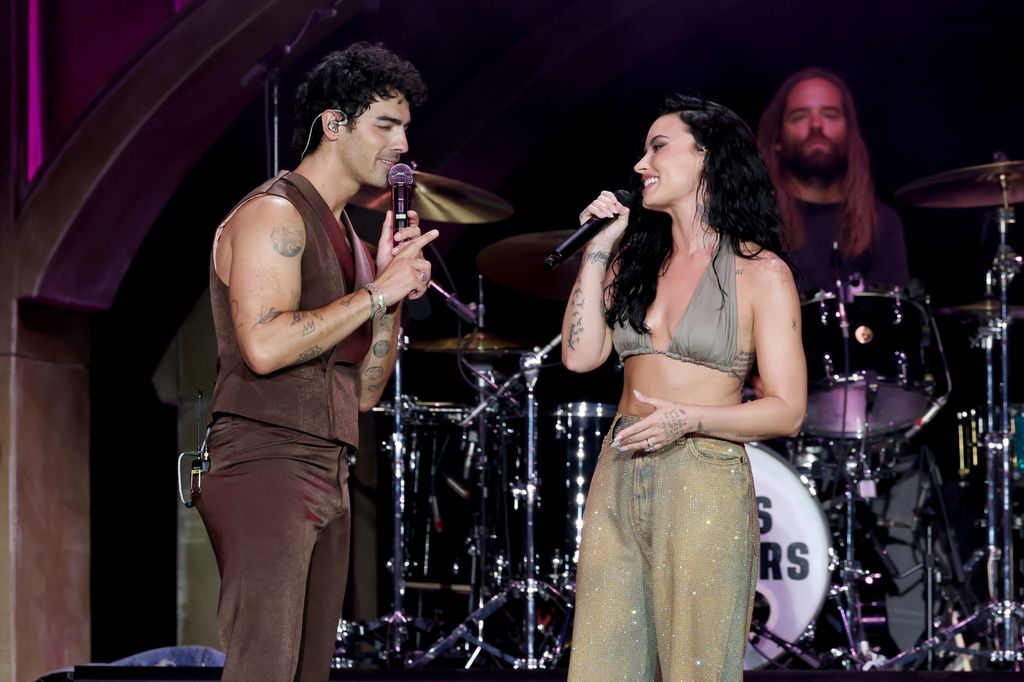 Joe Jonas and Demi Lovato perform onstage during the Jonas Brothers: JONAS20 Greetings From Your Hometown tour