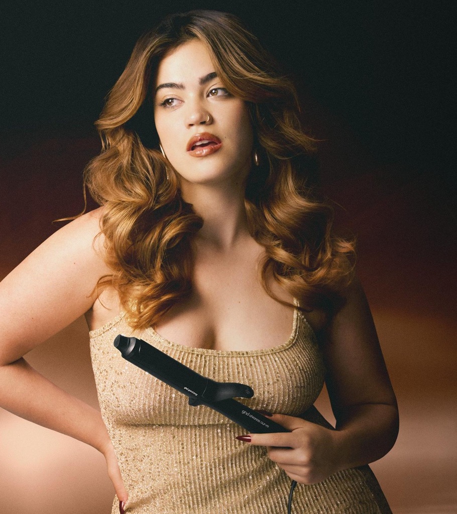 model with bouncy curls holding ghd curling wand