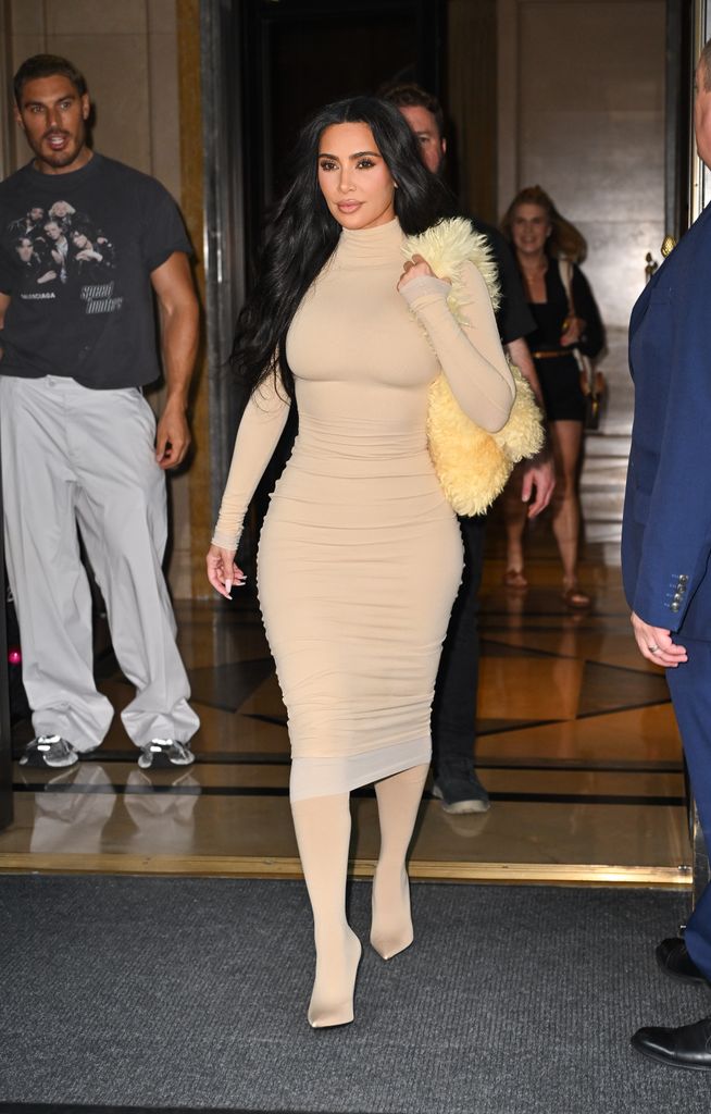 Kim Kardashian in beige dress and sock boots