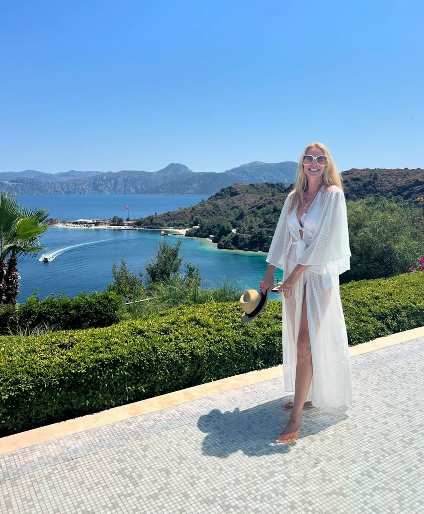 woman posing in bikini and beach cover-up