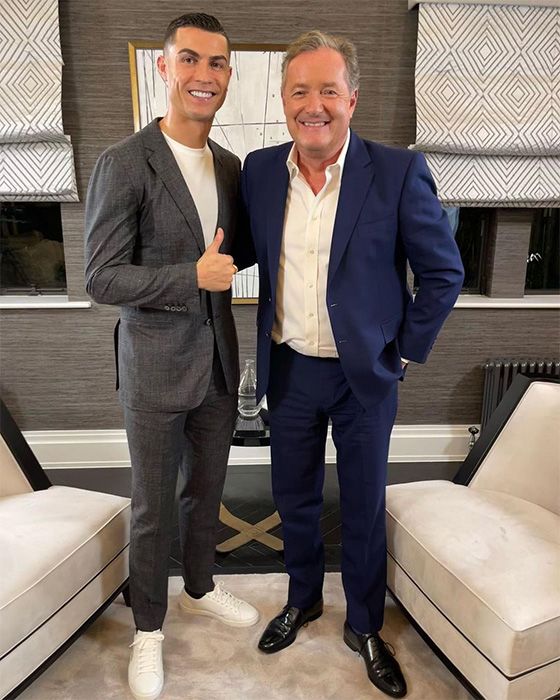 Piers Morgan and Cristiano Ronaldo posing together whilst smiling at the camera