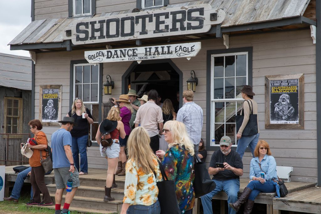 People enter his dance hall on Luck ranch