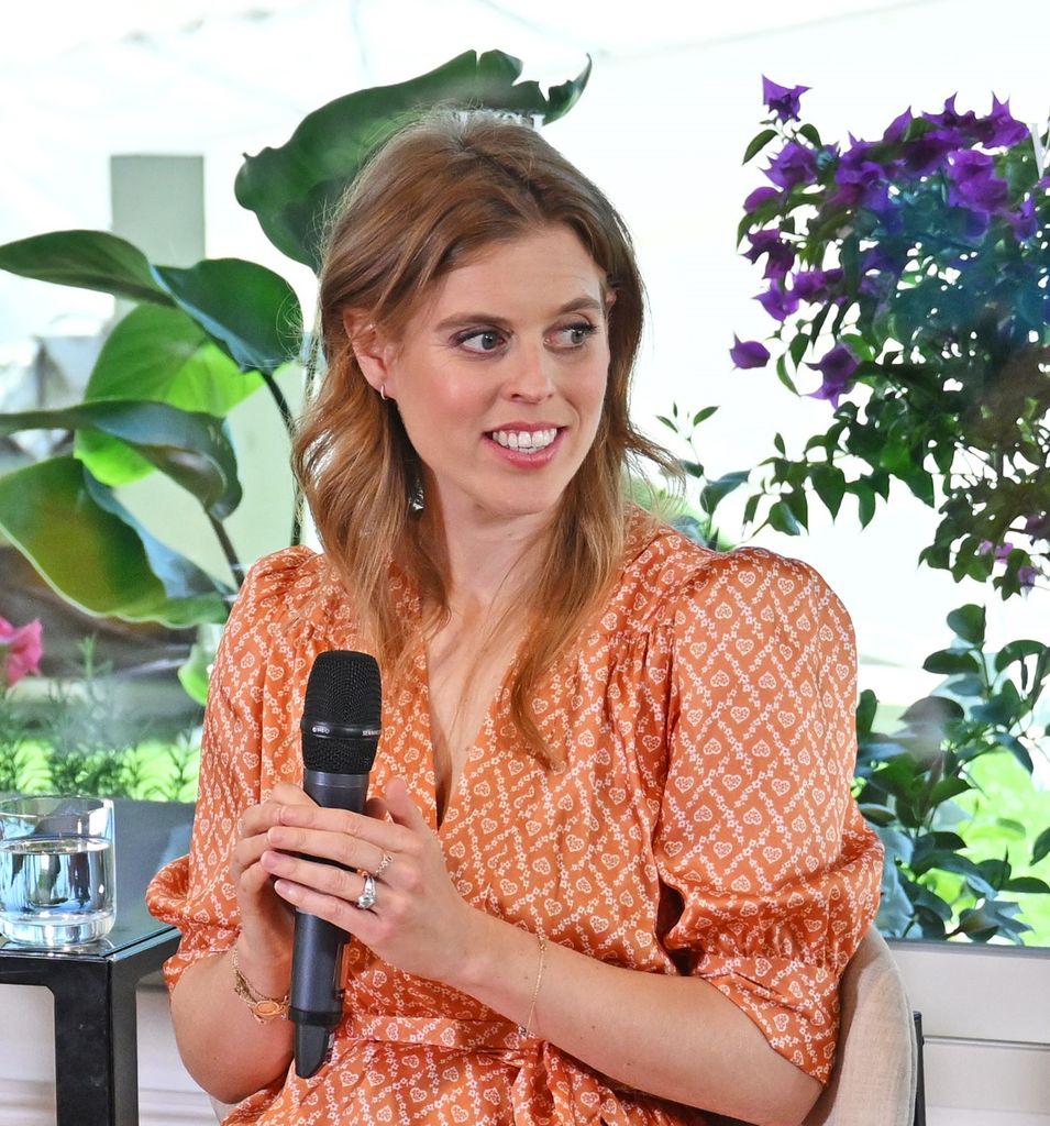 Princess Beatrice holding mic in peach dress