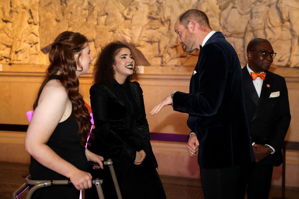 Prince William speaking with two young women