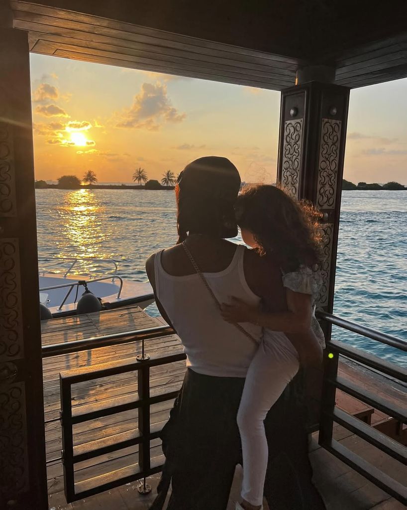 Naomi Campbell's daughter rests on her arms in a sunset photo from a family vacation to the Maldives, shared on Instagram