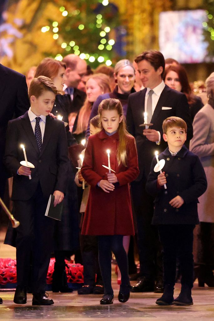 Prince George, Princess Charlotte and Prince Louis holding candles