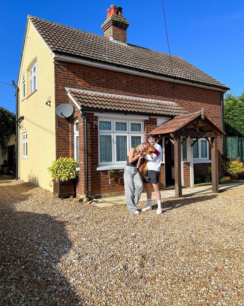 Tasha Ghouri and Andrew Le Page pose with their dog Luna outside their home