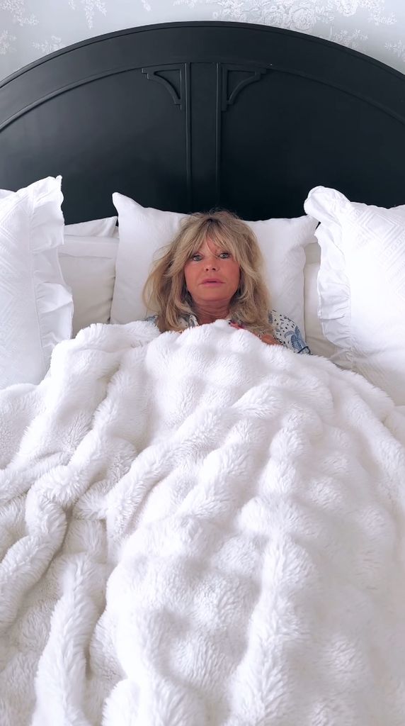 Goldie Hawn lies in her bed