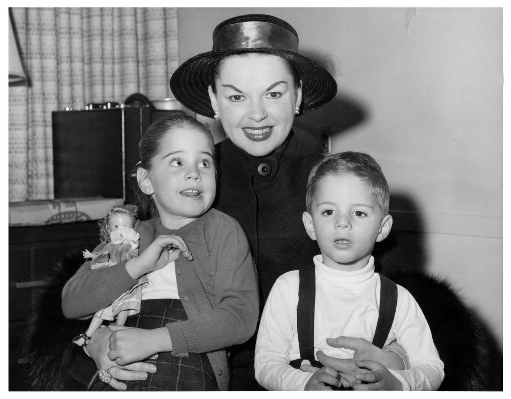 Actress Judy Garland (1922-1969) holds her children Lorna Luft and Joey Luft aboard a ship on a trip to Europe in a candid shot taken in 1957, United States