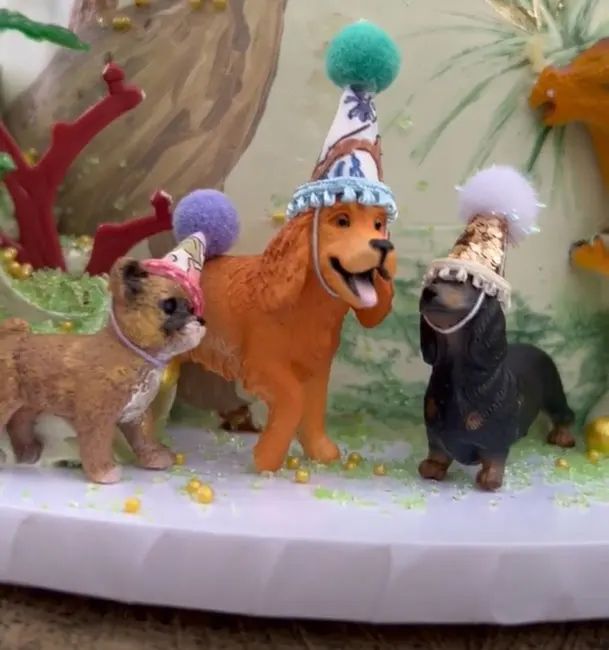 a close up photo of dogs made of fondant each wearing pointed party hats