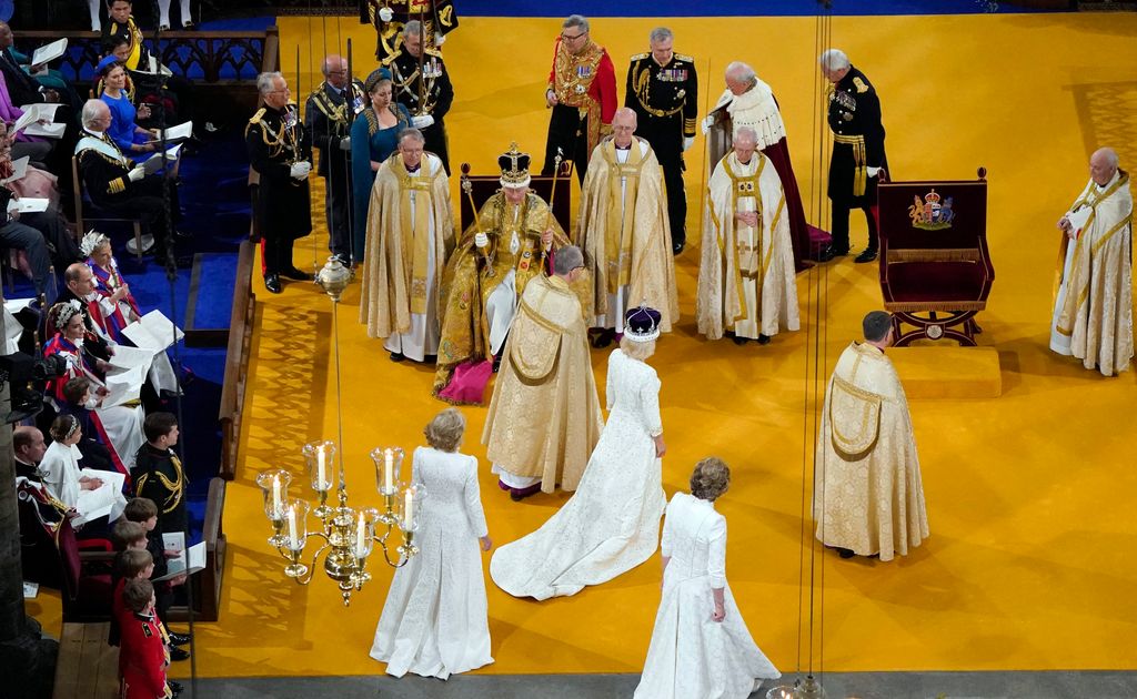 Camilla walks wearing a modified version of Queen Mary's Crown as Britain's King Charles III wearing the St Edward's Crown on his head sits during the Coronation Ceremony inside Westminster Abbey