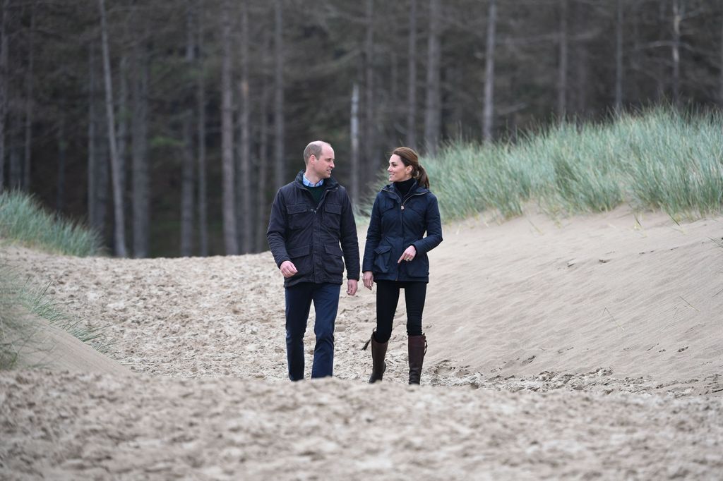 Prince William and Princess Kate walking on the beach