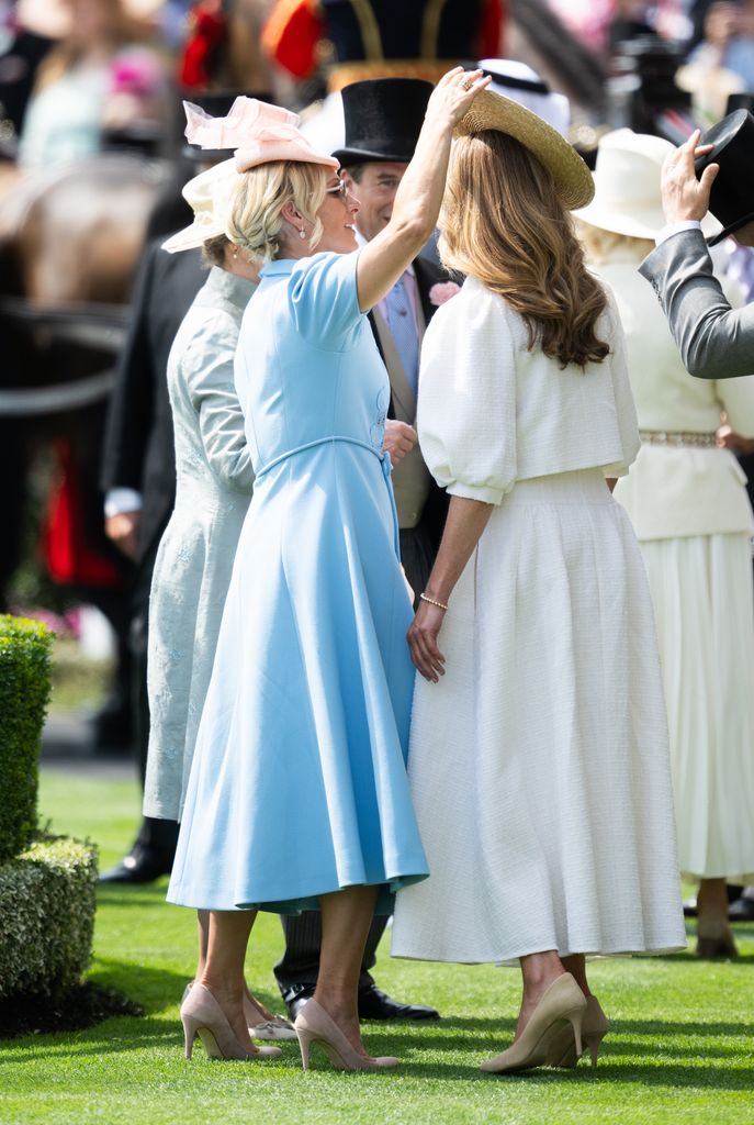 Zara Tindall helping her brother's girlfriend with her hat 