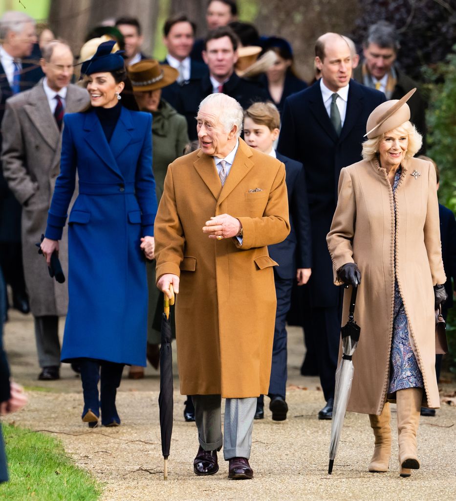 King Charles and Queen Camilla walking with Kate Middleton, Prince George and Prince William behind them